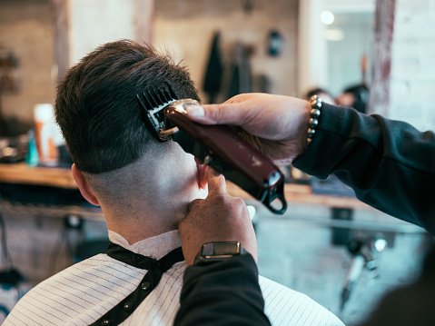 busy day at english style barber shop with clients and barbers.